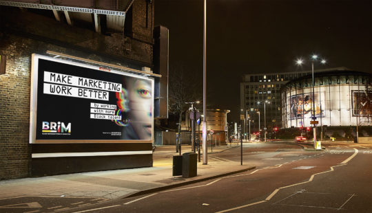 Photo of an empty road at night outside the London IMAX. A billboard under a lit bridge shows the BRiM campaign creative with the headline “Make marketing work better by working with more Black talent”